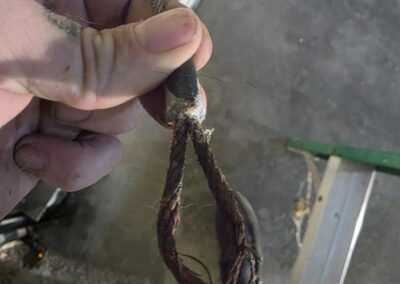 A rusty, broken, garage door cable that snapped off of a customers garage door.