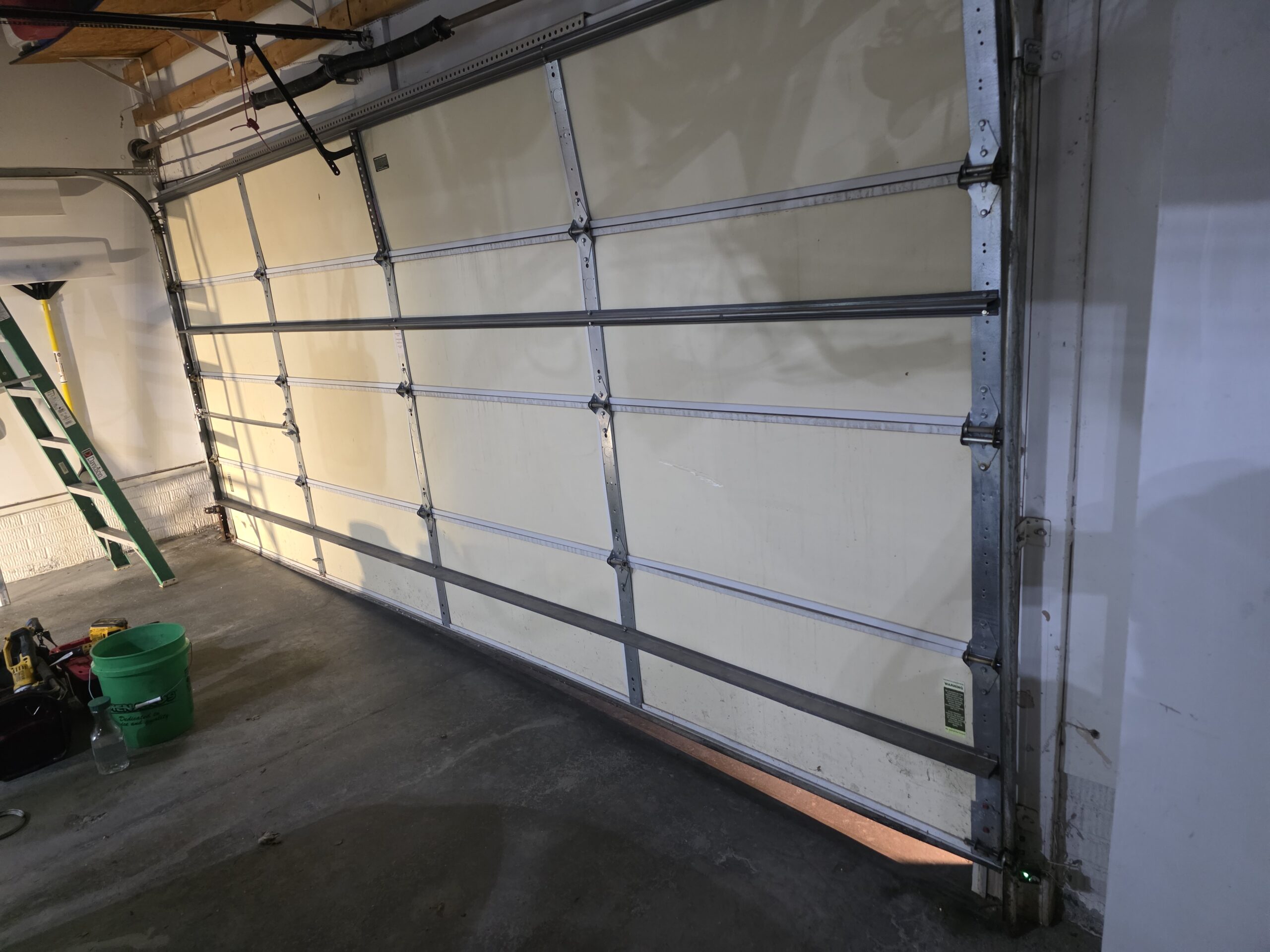 Off track garage door repaired by Gelvin Garage Doors after a rusty cable snapped.