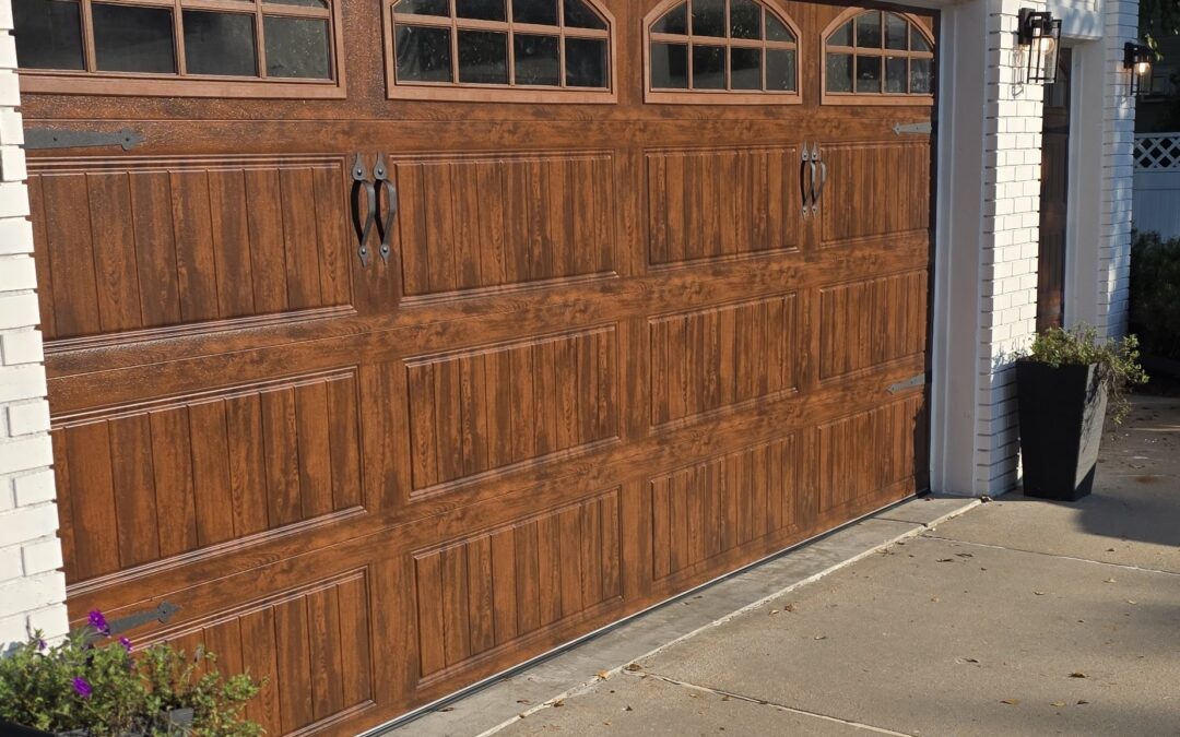 Light oak long panel bead board garage door with windows and inserts.